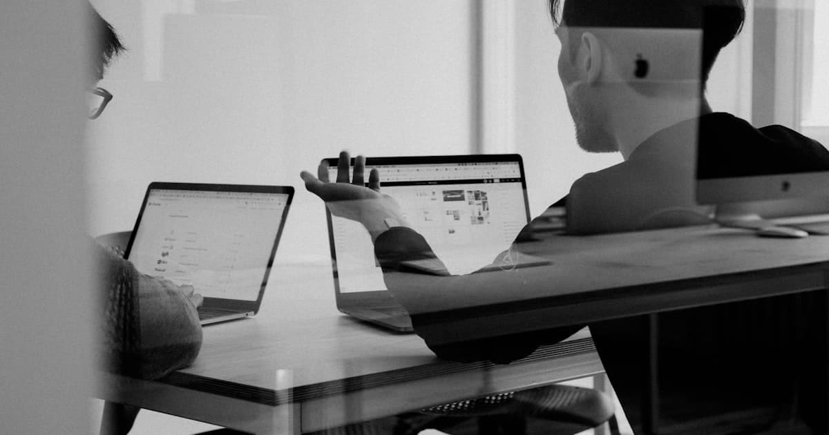 Person working with software interface on a laptop screen.